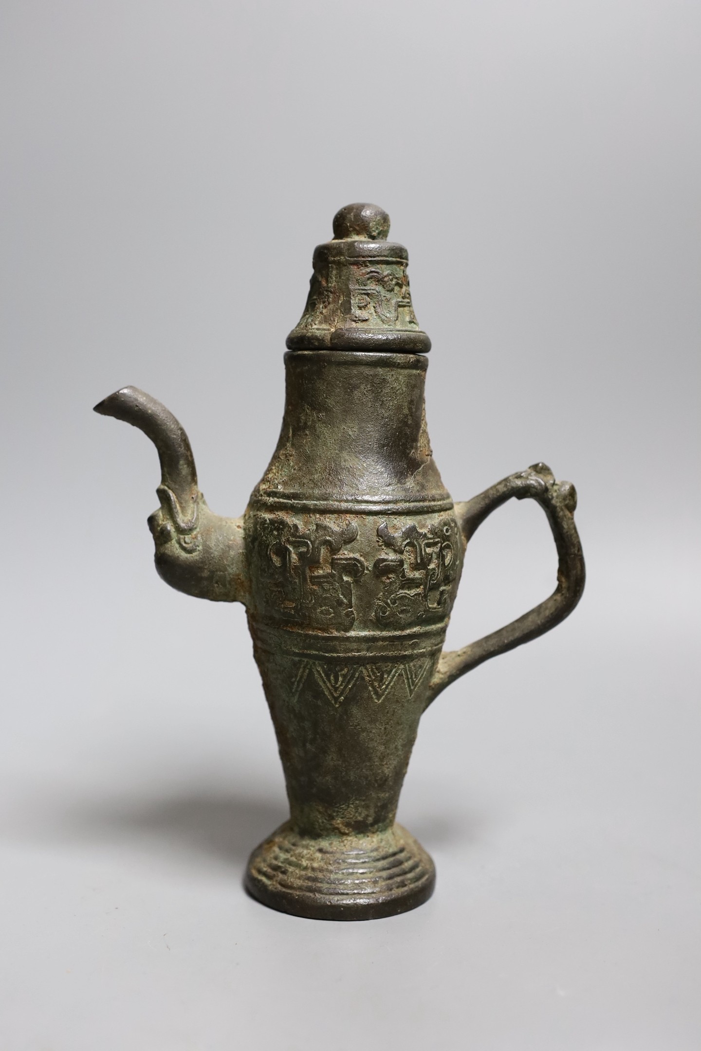 A Chinese archaistic bronze pouring vessel and cover, 17th/18th century, 22cms high